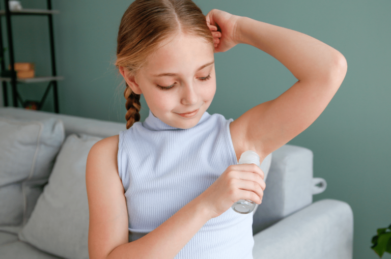 Young girl apllying deodorant